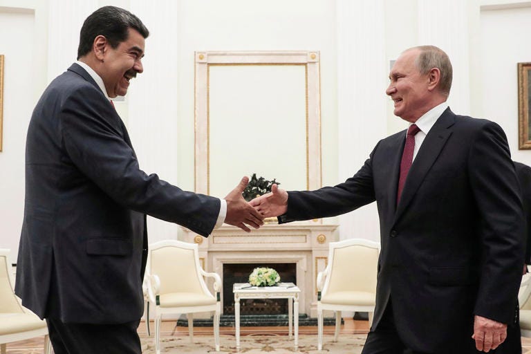 Russian President Vladimir Putin is about to shake hands with Venezuelan President Nicolas Maduro during their meeting at the Kremlin in Moscow on Sept. 25, 2019.