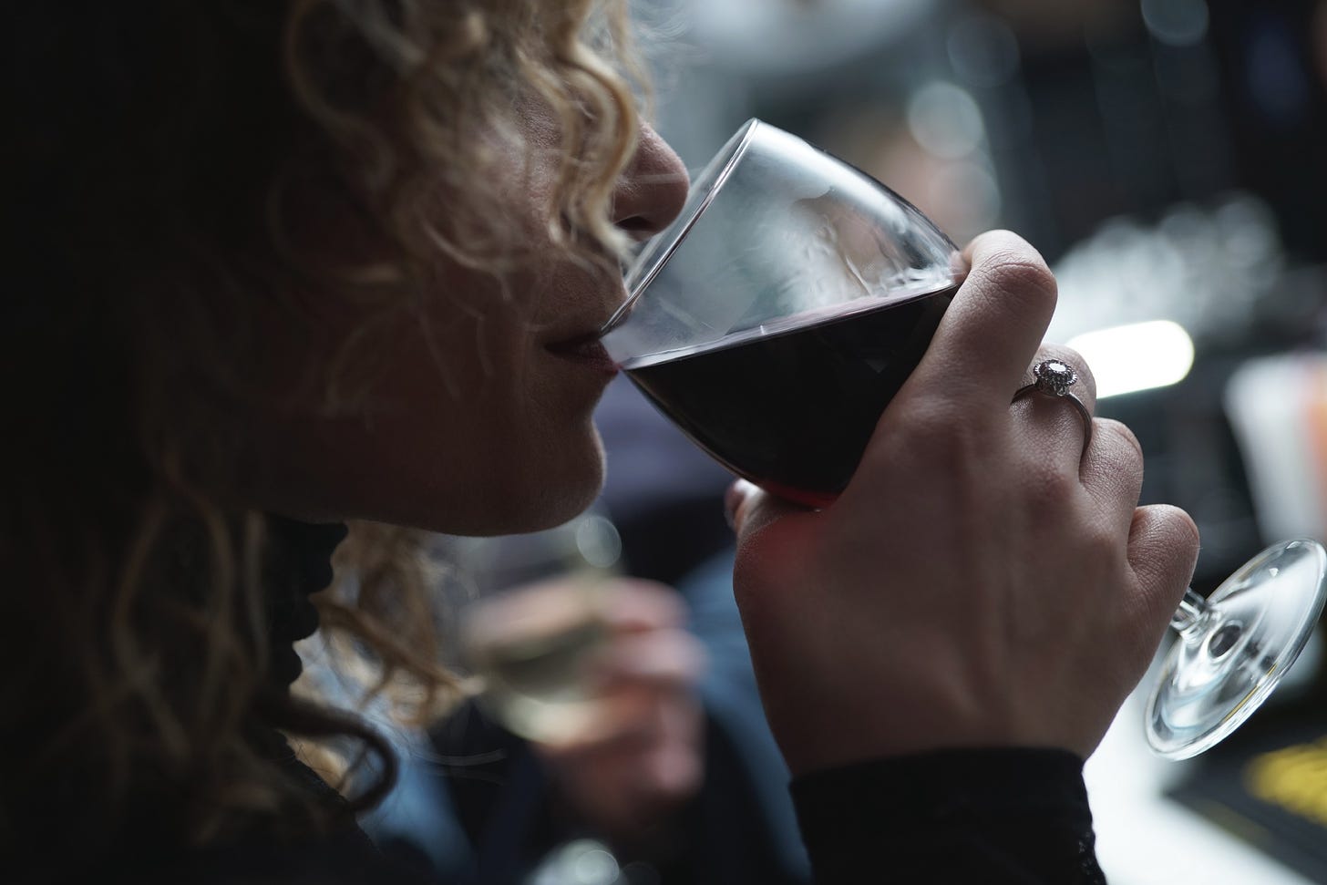 image of a woman drinking red wine for article titled “When Two Bottles of Wine Doesn’t Work”