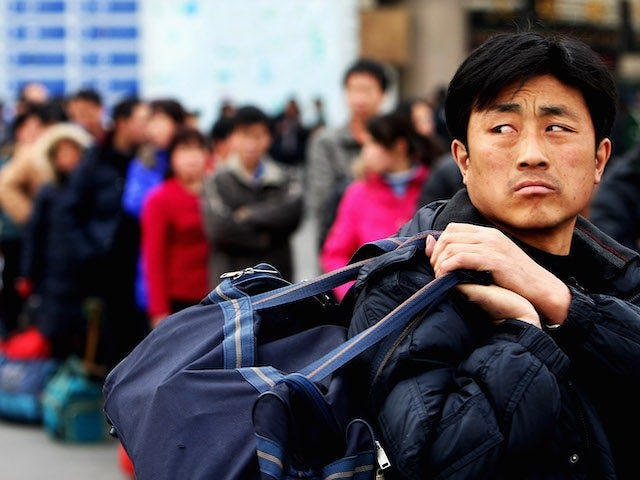 Migrants arrives at the West Railway Station with their luggage on February 2, 2009 in Beijing, China. After the week-long Chinese New Year holiday, millions of migrants return cities early aimed to find works. About 20 million migrant workers have lost their jobs because of the economic downturn, a senior …