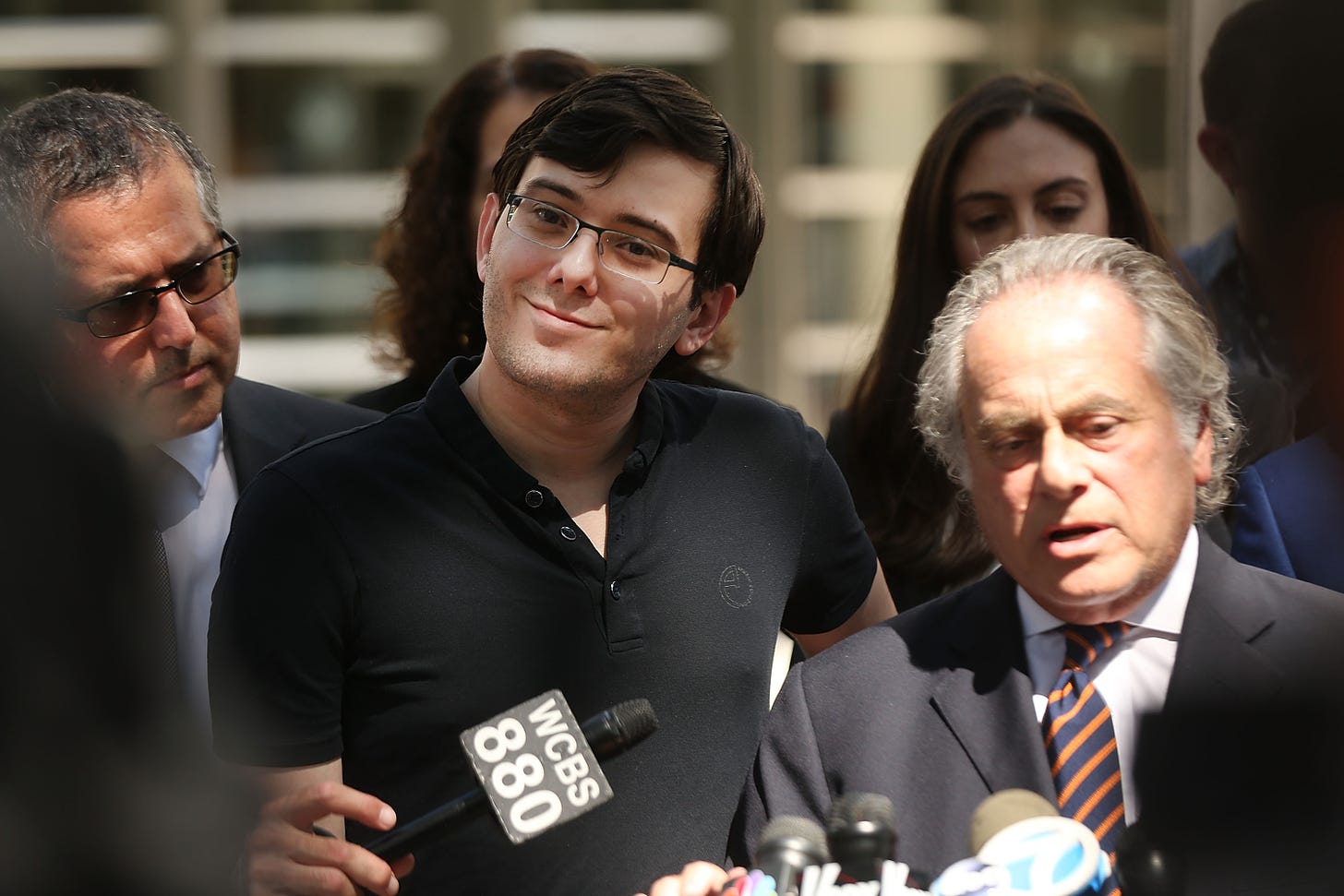 Martin Shkreli outside the courthouse in Brooklyn after his conviction in August 2017. Defense lawyers Marc Agnifilo (left), Benjamin Brafman (right) and Andrea Zellan and Teny Geragos (behind) also pictured. (Getty Images)