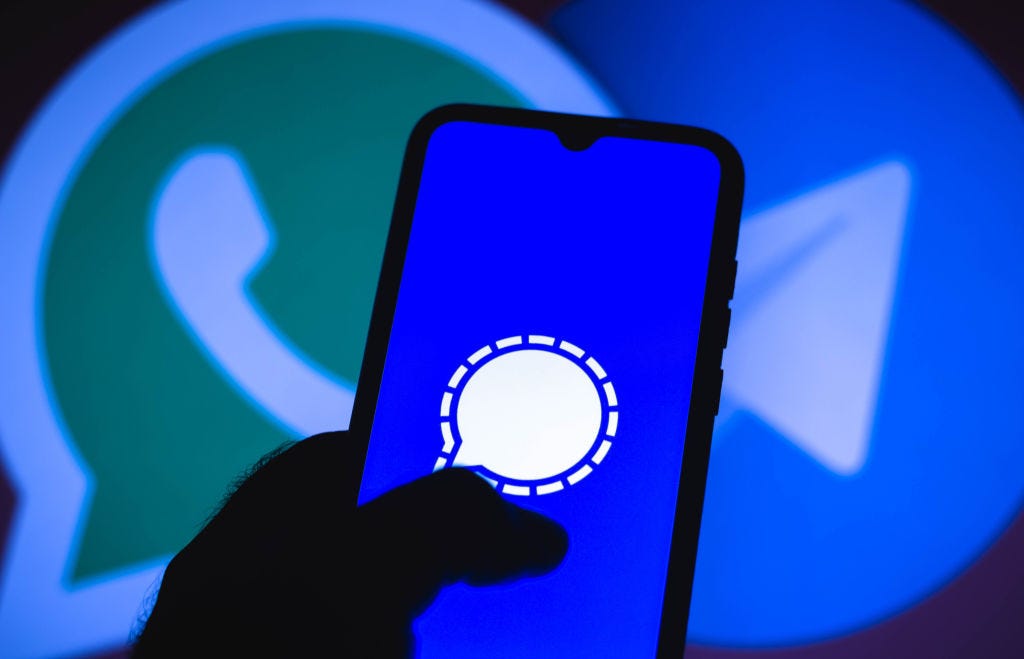 Photo illustration of Signal against a backdrop of WhatsApp and Telegram app icons. (Rafael Henrique / Getty Images)
