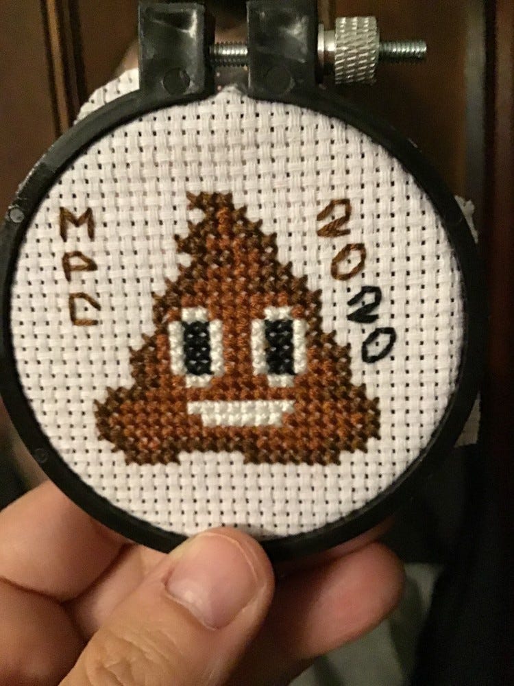 cross-stitch of poo emoji