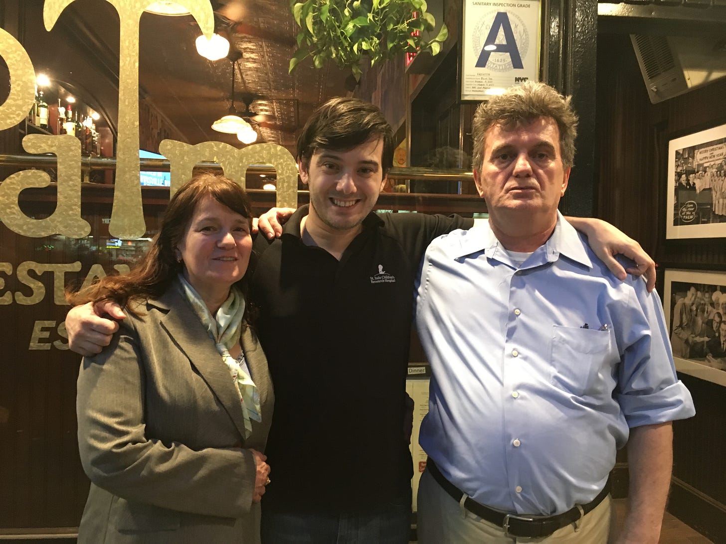 Martin Shkreli (center), his mother Katrina (left) and father Pashko (right). They are standing in front of The Palm in Manhattan in 2017.