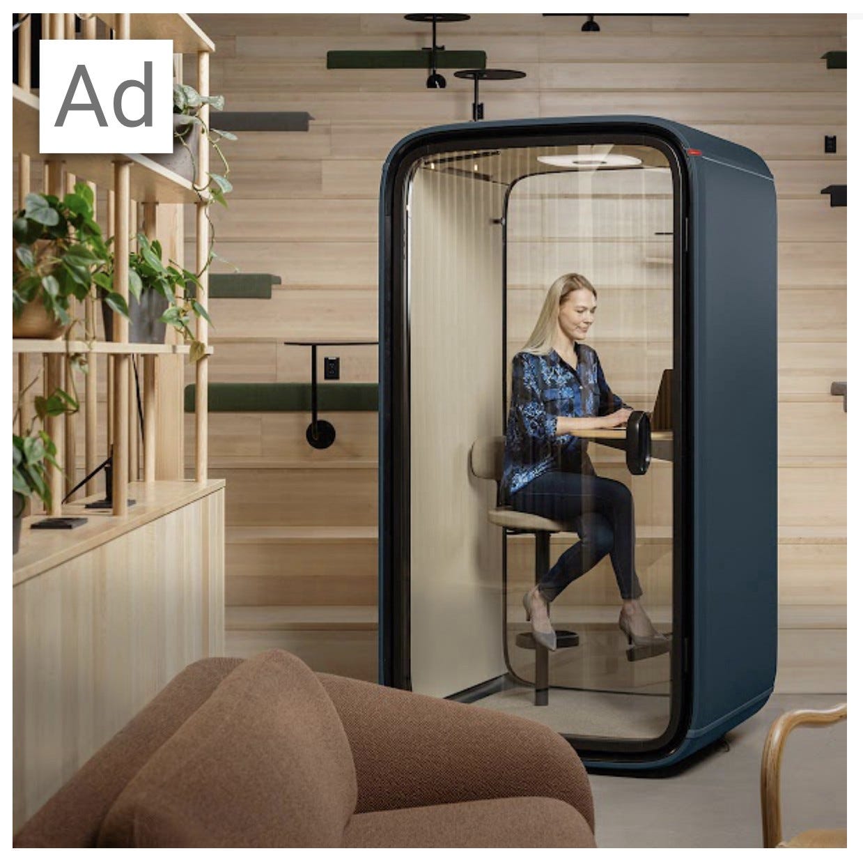 An ad for a soundproof isolation booth from Spacify.