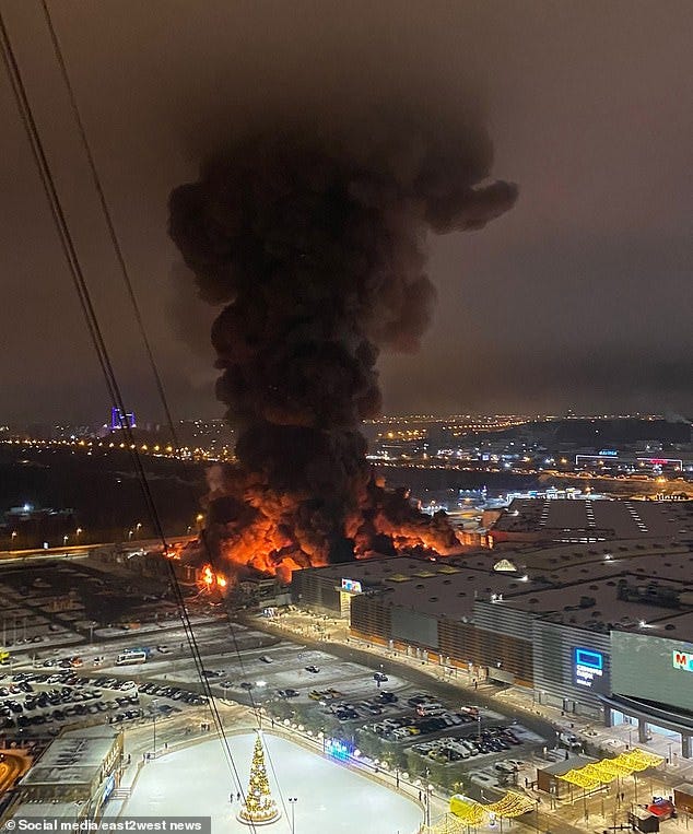 Thick black smoke shoots into the sky at a shopping mall housing the first Russian IKEA store. Moscow, December 9