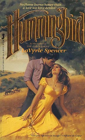 Book cover of Hummingbird by LaVyrle Spencer. A woman in a yellow dress is being held in the arms of her lover, a man with dark hair and jeans. They are embracing in front of a tornado .