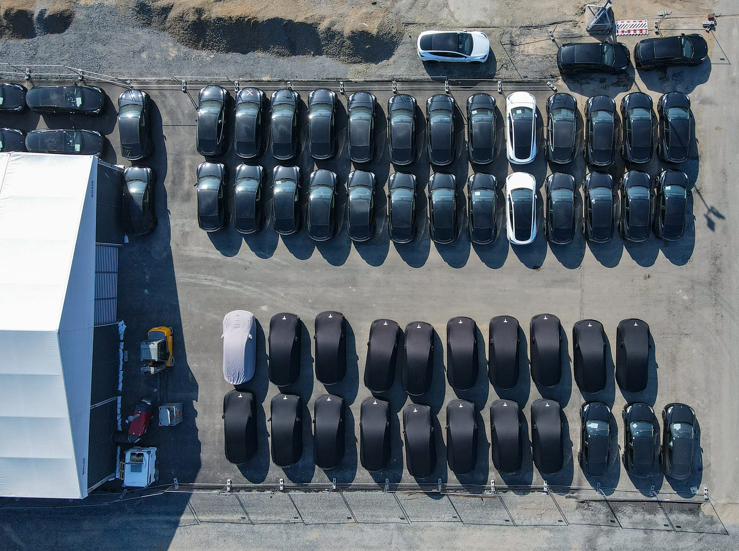 Many Tesla Model Y electric vehicles are parked on the grounds of the Tesla Gigafactory Berlin Brandenburg (aerial view with a drone). For March 22, 2022, Tesla has invited, in addition to employees and high-ranking politicians, about 30 customers to the handover of their new Model Y from Grünheide. The first European factory in Grünheide, which is designed for 500,000 vehicles per year, is an important pillar of Tesla's future strategy. Photo: Patrick Pleul/dpa-Zentralbild/ZB (Photo by Patrick Pleul/picture alliance via Getty Images)
