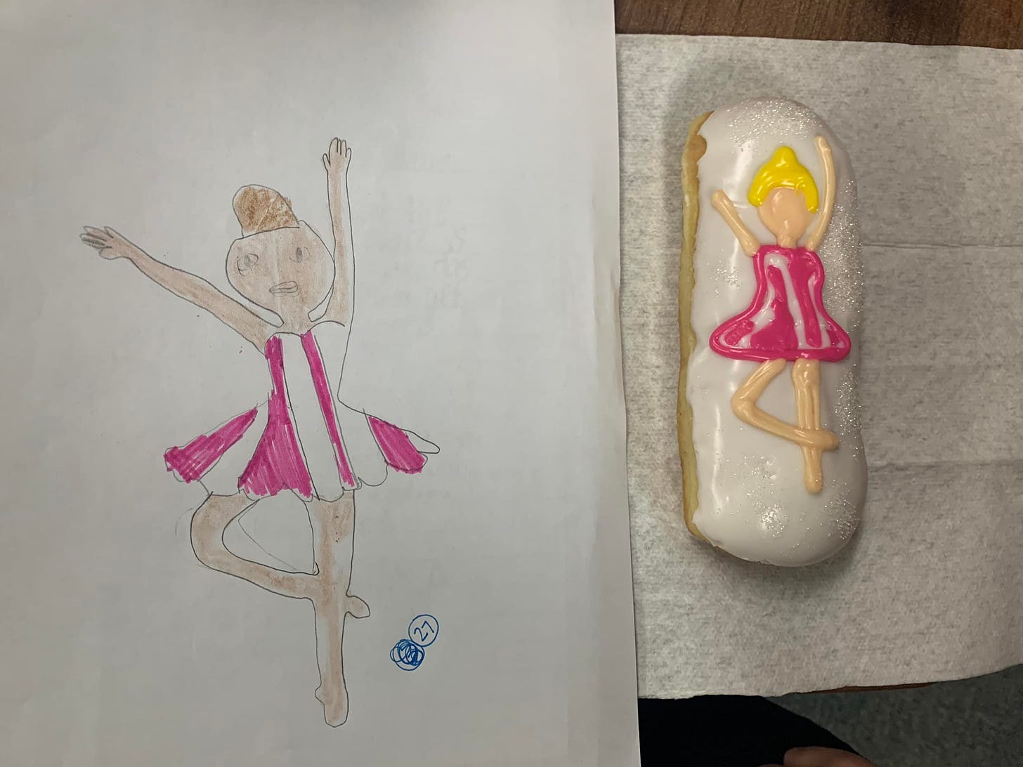 A drawing of a ballerina and a matching donut