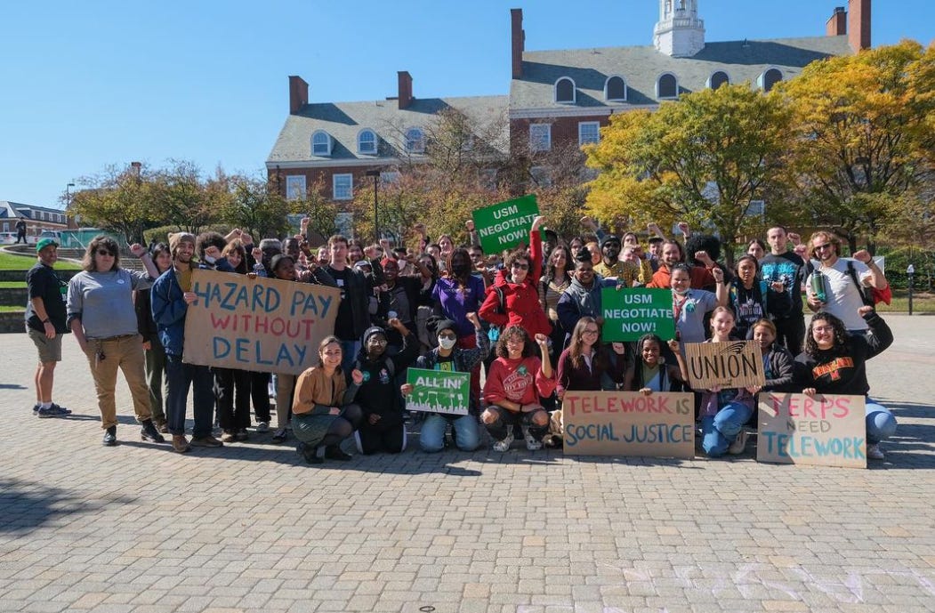Group portrait of campus workers (including undergraduate and graduate students, faculty, and staff) gathered in Hornbake Plaza at the University of Maryland-College Park.