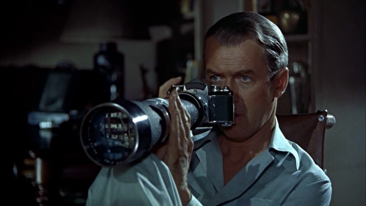 Jimmy Stewart holding a camera in Hitchcock's "Rear Window" (1954)