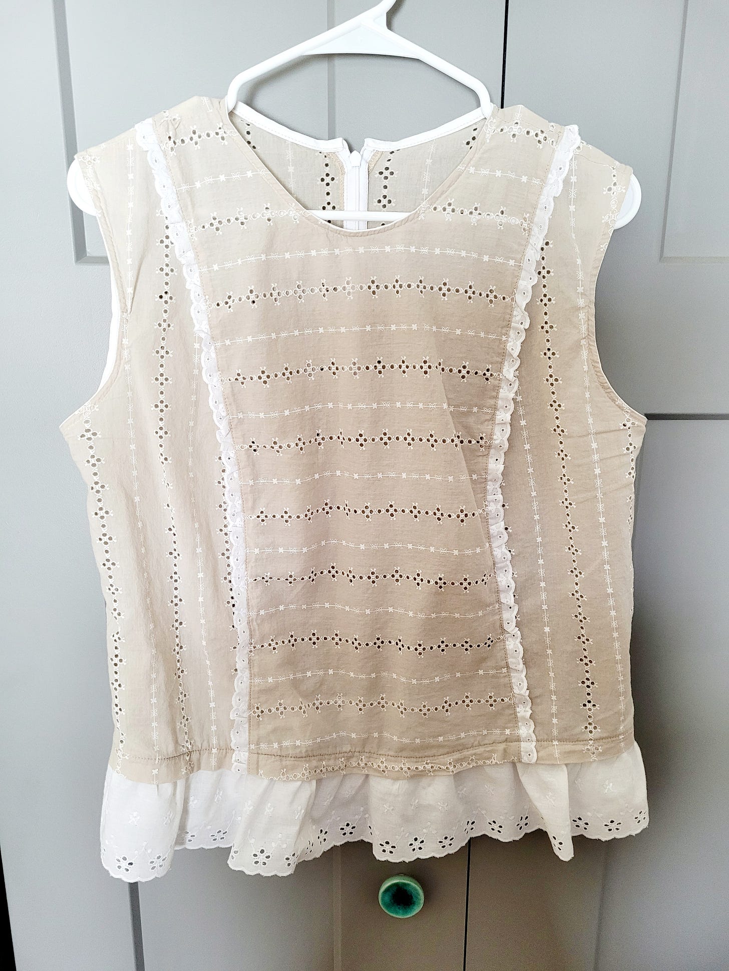 An eyelet top I recently finished, sleeveless beige with white eyelet trim in the princess seams and around the bottom hem, McCall's pattern #8096