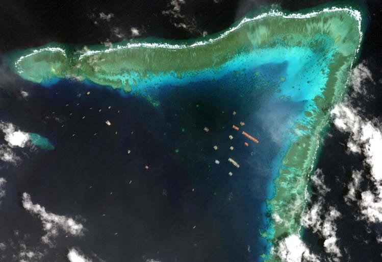 Chinese ships off of Whitsun Reef, 320 kilometers west of the Philippine island of Palawan. What China deems legal is regarded by the Philippines as an illegal intrusion into its own exclusive economic zone.