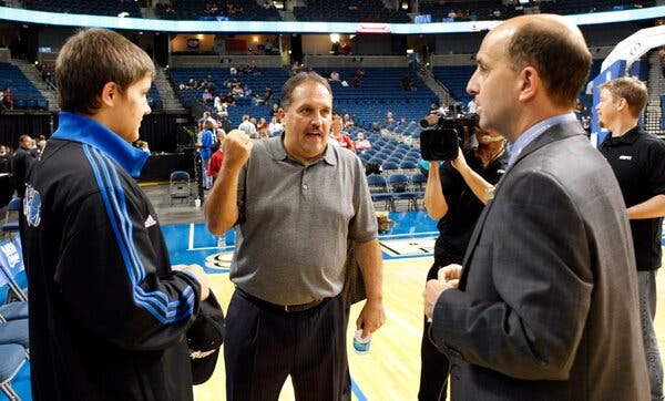 Stan Van Gundy, center, shown in 2010 talking to his brother, Jeff, of ESPN and about the cancellation of an Orlando Magic preseason game.