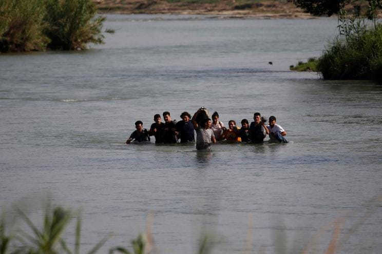 Migrants, mostly from Nicaragua, cross the Rio Grande river into the U.S., at Eagle Pass, Texas, Friday, May 20, 2022.