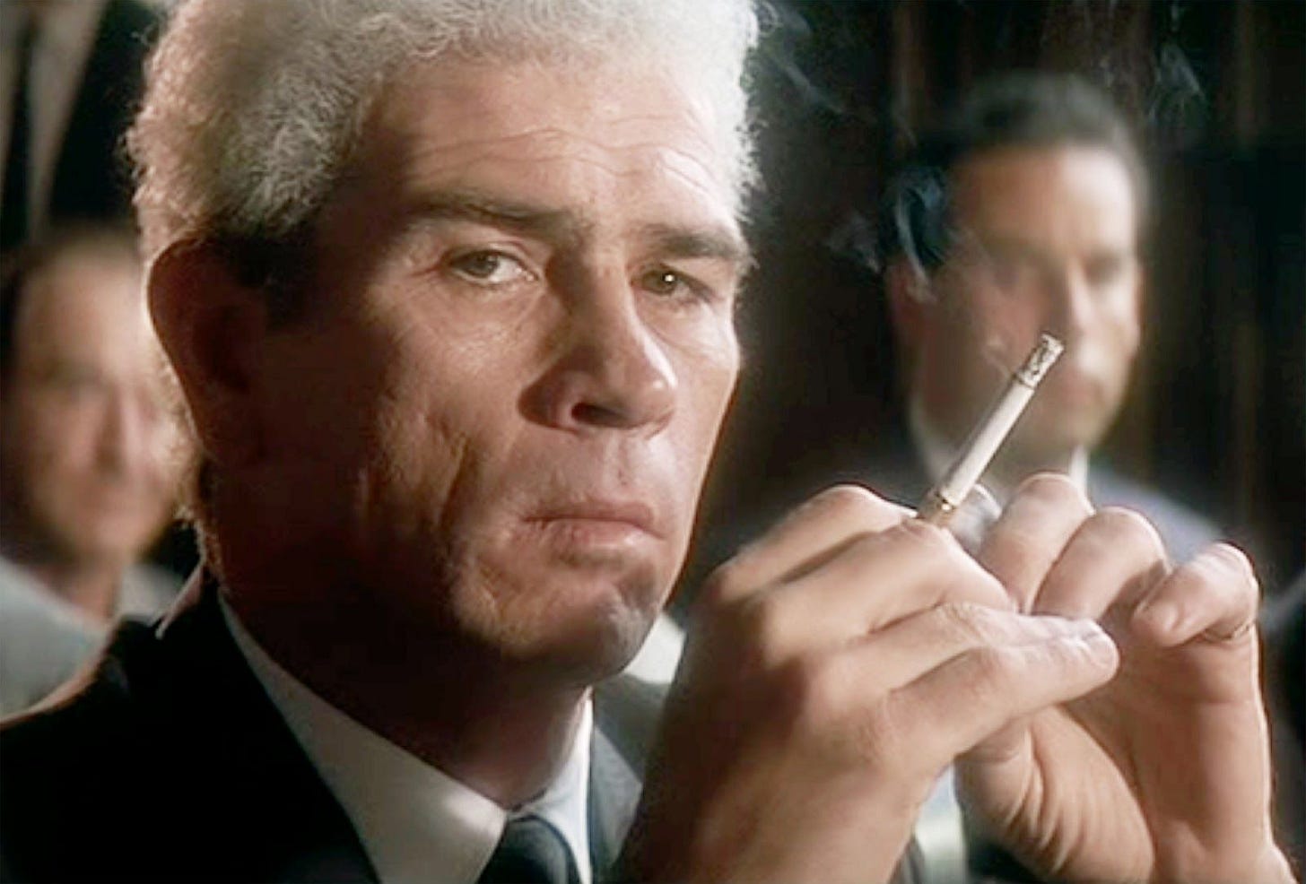 This image shows Clay Shaw (played by Tommy Lee Jones) holding a cigarette and listening to testimony during his trial as dramatized in Oliver Stone's 1991 film JFK. This image shows Clay Shaw (played by Tommy Lee Jones) holding a cigarette and listening to testimony during his trial as dramatized in Oliver Stone's 1991 film JFK.