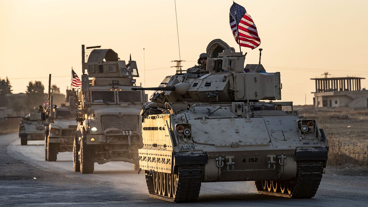 A convoy of U.S. military vehicles drives near the town of Tal Tamr in the northeastern Syrian Hasakeh province, on the border with Turkey, on Nov. 10, 2019. (Credit: Delil Souleiman / AFP / Getty Images)