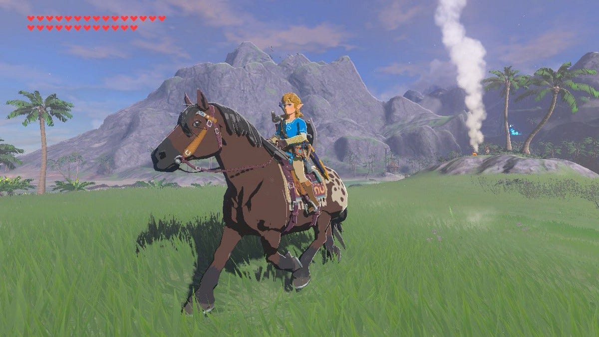Link riding his horse across a coastal field.