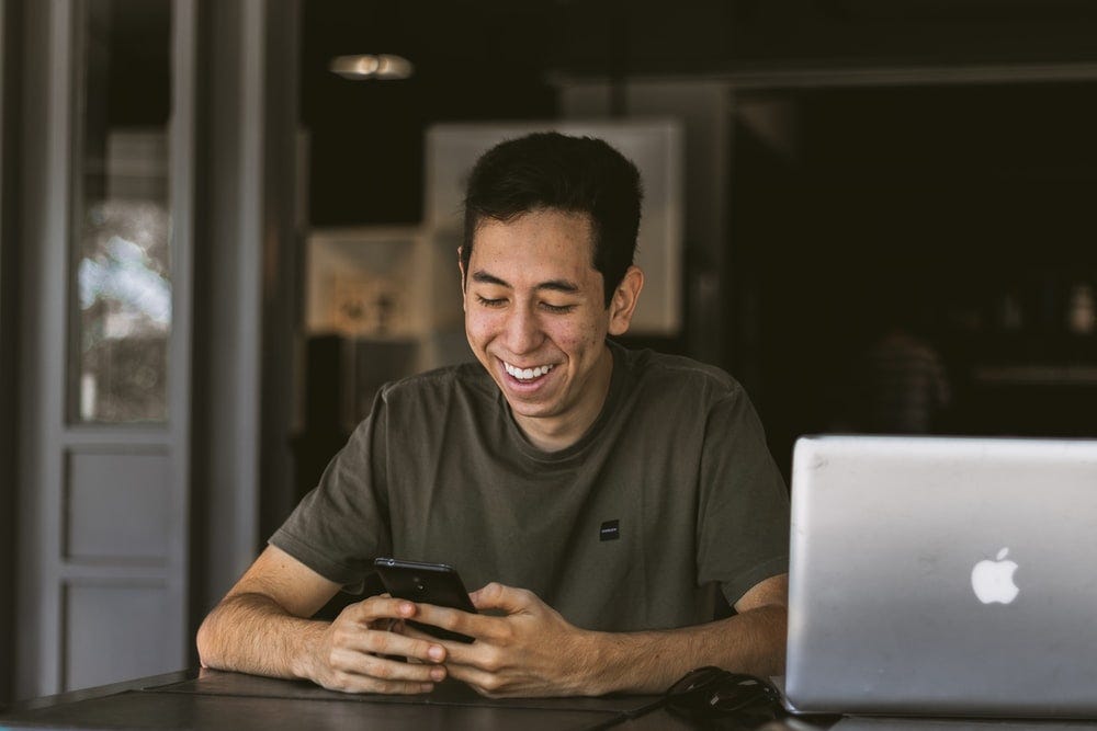 Image result for smiling men looking at MacBook