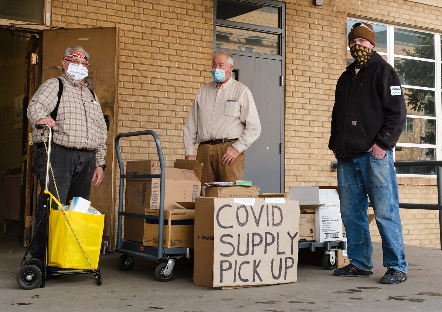 Faculty members (left to right) John Benedik, Bill McCleary and Peter Wolfinbarger at the north side Crane Hall loading dock hand out COVID supplies
