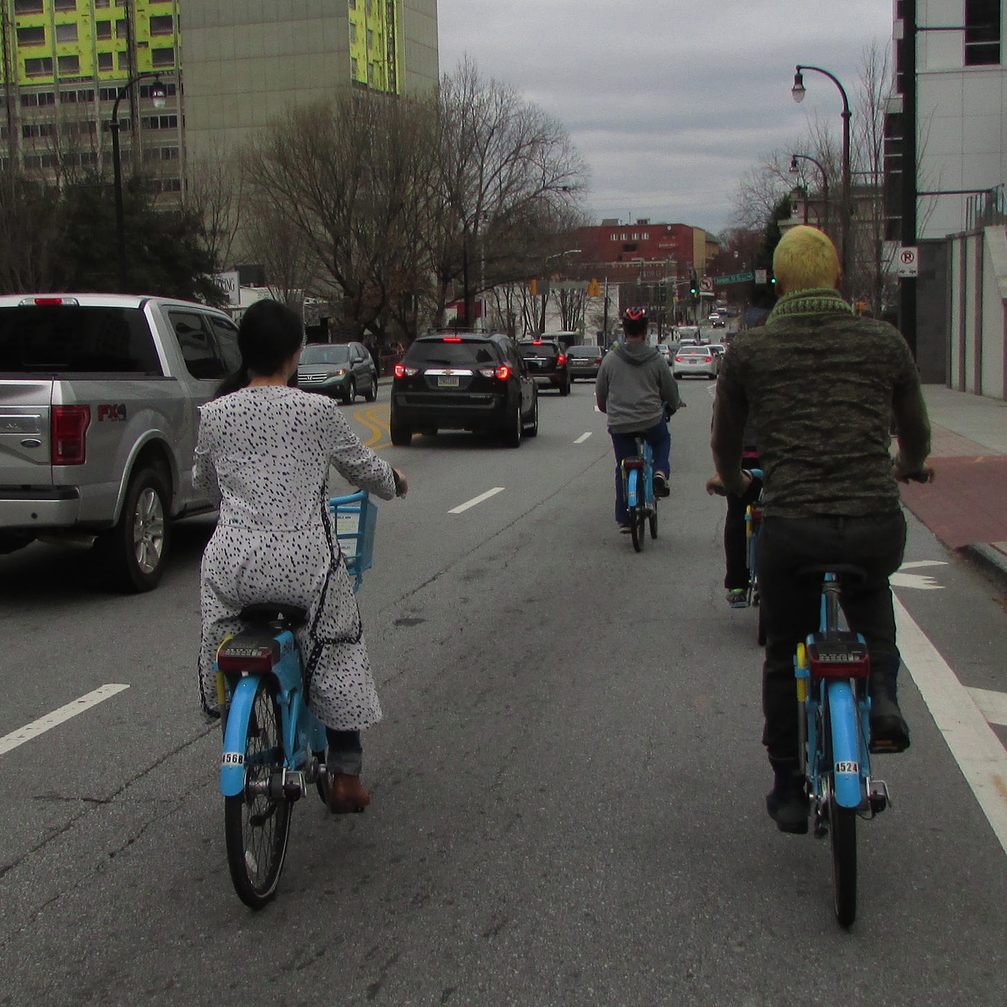 Photo showing two people riding bikes side by side