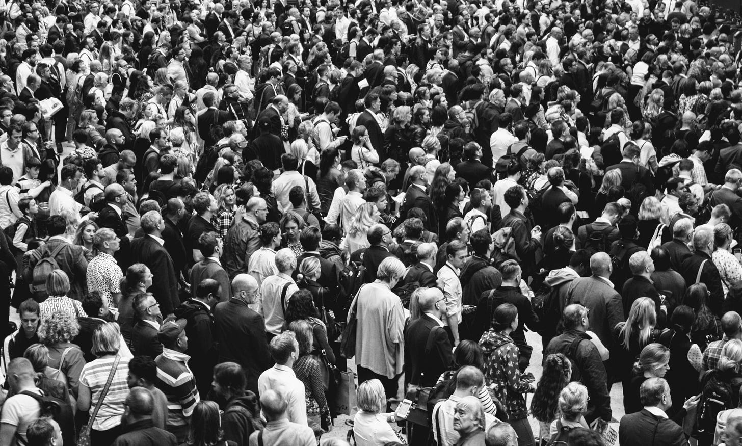 black and white image of a crowd for article by Larry G. Maguire