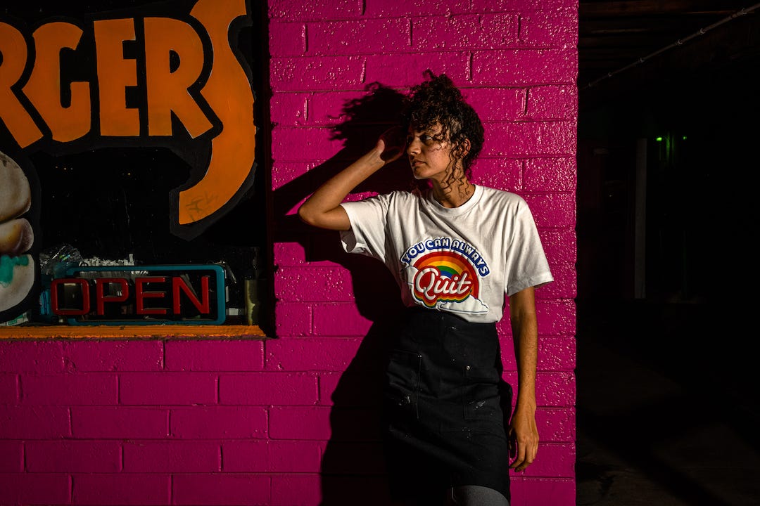 Photo of the only Queen I recognize wearing the You Can Always Quit t-shirt in white. 