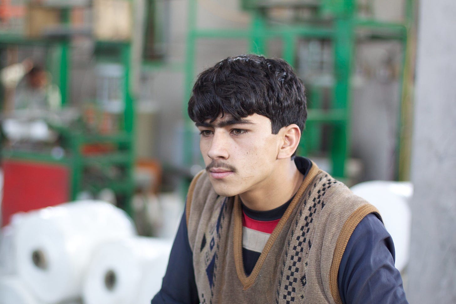 An  Afghan youth. About 64% of Afghans are under age 25, according to the UNFDP. Creative Commons photo by Todd Huffman.