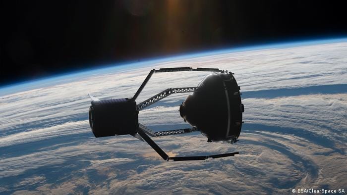 A satellite is seen grabbing another satellite in Earth orbit