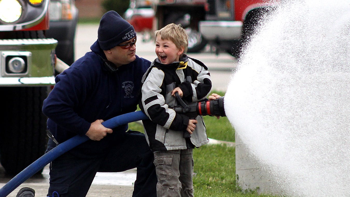 Becoming a fire fighter is often a huge goal for young boys and girls. At a “touch-a-truck” fundraiser for a local schools event, this boy’s dream came true when he was allowed to operate a fire hose. His facial expression is self-explanatory.