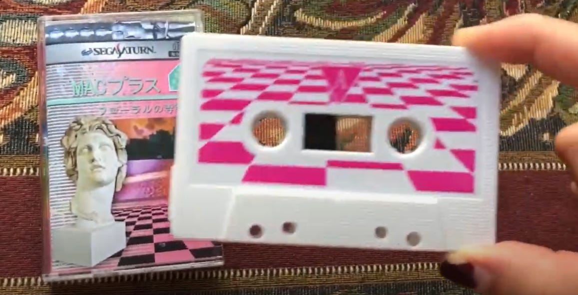 Person holding a cassette copy of Macintosh Plus' Floral Shoppe