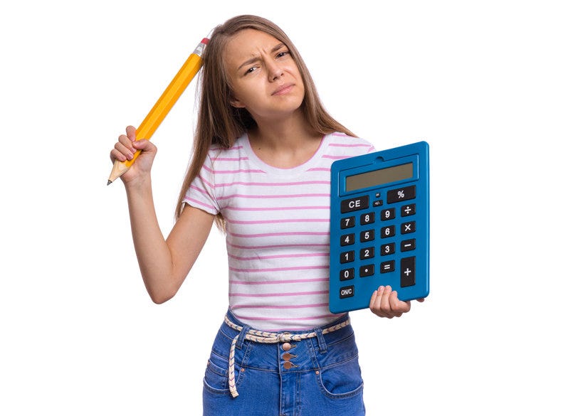 Student holding a calculator and pencil.