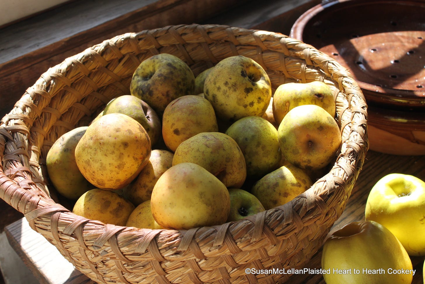 basket of mottled yellow apples in kitchen sunshine 