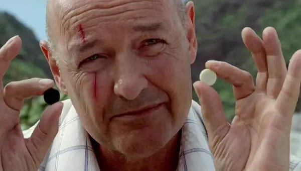 John Locke (Terry O'Quinn) holds up two game pieces: one black, one white.