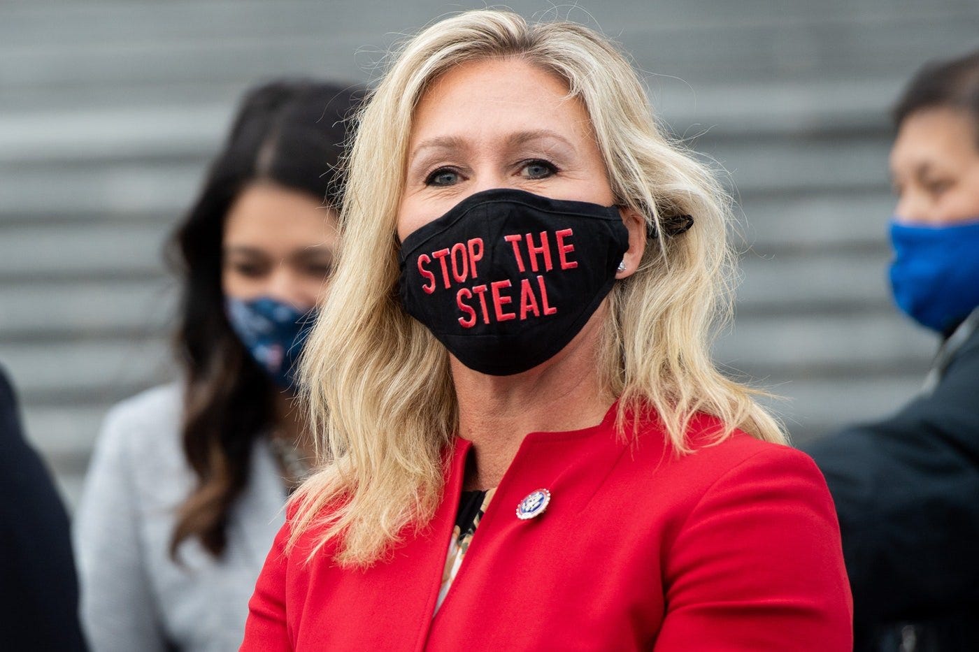 Marjorie Taylor Greene wears a "Stop The Steal" mask.