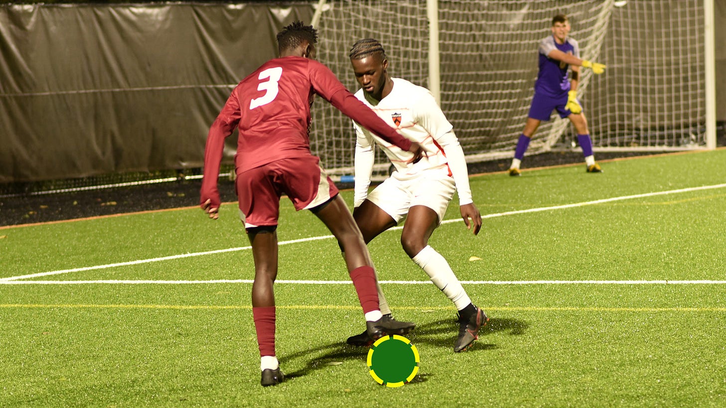 Two soccer players in action with ball covered by green circle