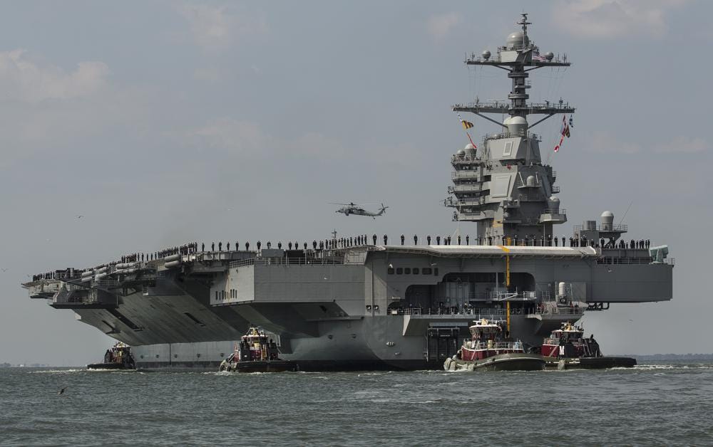 FILE - In this April 14, 2017 file photo, as crew members stand on the deck, the aircraft carrier USS Gerald R. Ford heads to the Norfolk, Va., naval station. The U.S. Navy’s most advanced aircraft carrier embarked on its first-ever deployment Tuesday, Oct. 4, 2022,  and will train with other NATO countries at a time of increasing Russian aggression in Ukraine.  The USS Gerald R. Ford left the world’s largest Navy base in Norfolk, Virginia, along with destroyers and other ships that make up its carrier strike group.  (Bill Tiernan/The Virginian-Pilot via AP, File)