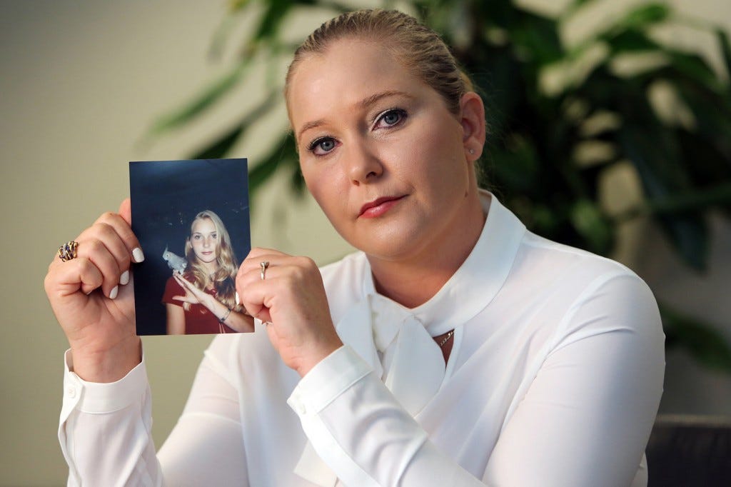 Virginia Roberts holds a photo of herself at age 16.