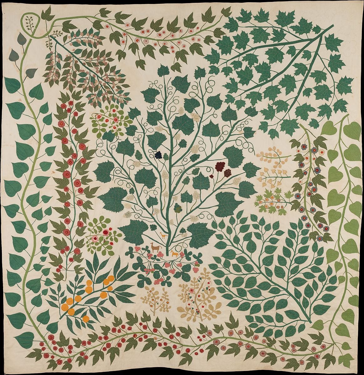 Tree of life quilt with green vines and leaves, and different colored berries and flowers.