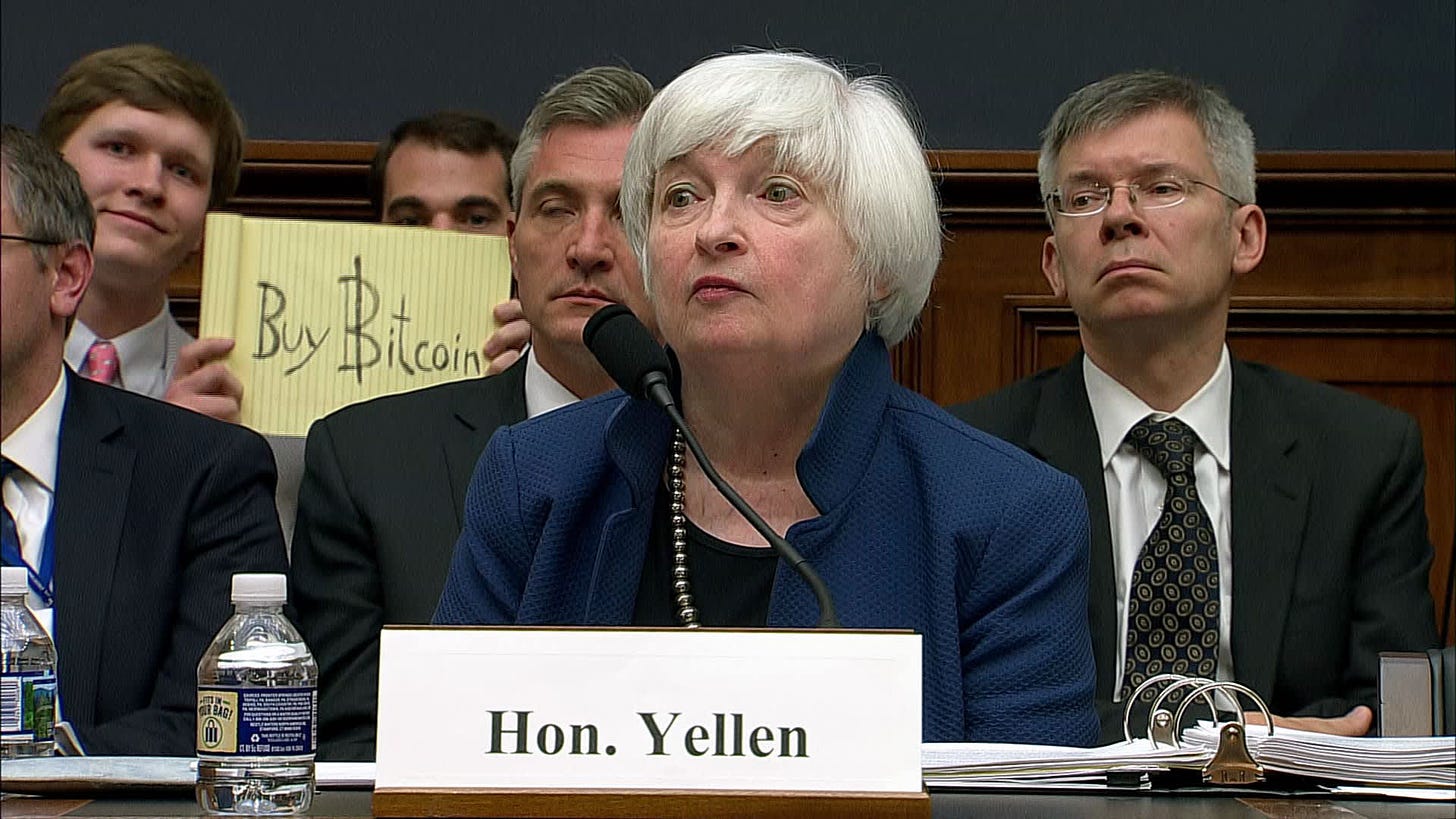 Someone holds up &#39;buy bitcoin&#39; sign during Yellen testimony to Congress