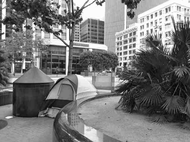 Homeless person camping in a tent on the streets of San Francisco