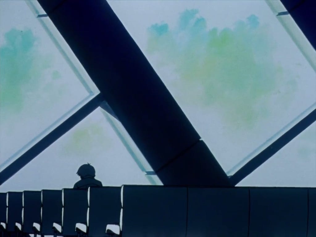 Shinji sitting in front of the hospital windows.