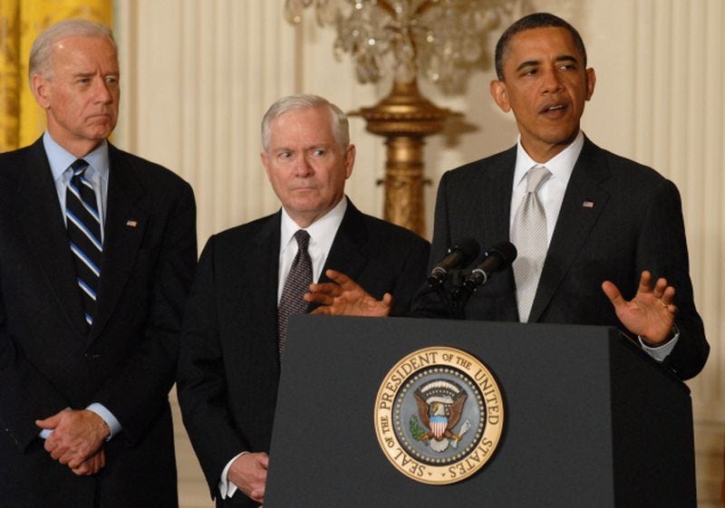 President Barack Obama (right) stands with Vice President Joe Biden (left) and former Defense Secretary Robert Gates (center) in 2011.