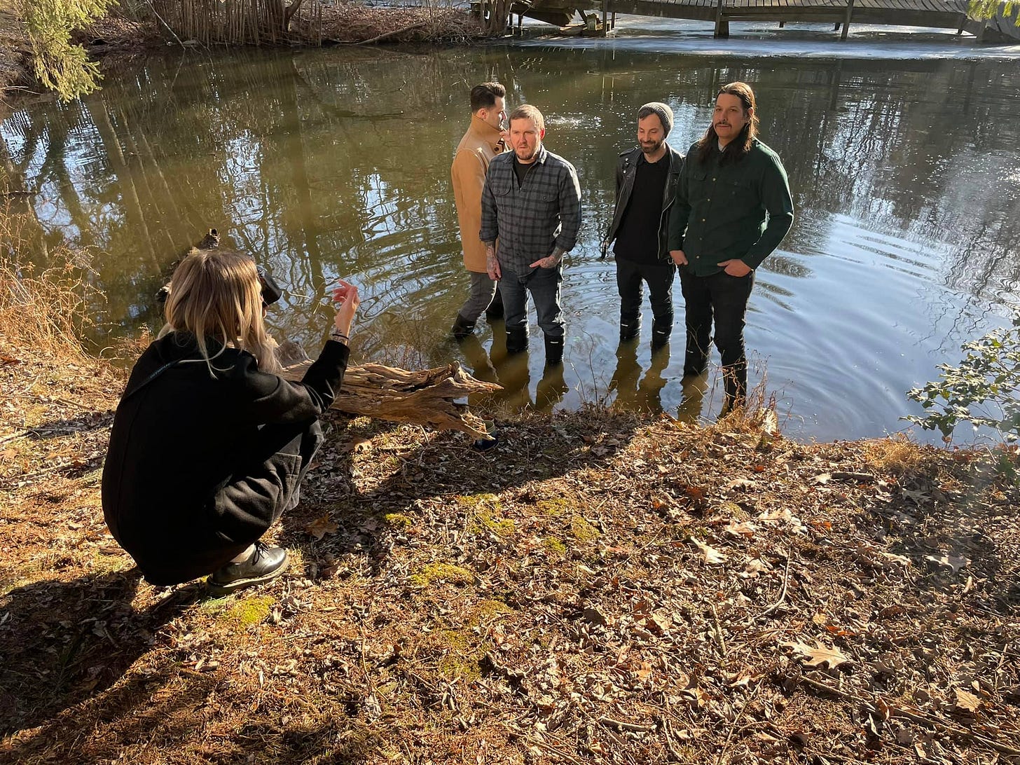 May be an image of 5 people, people standing and body of water