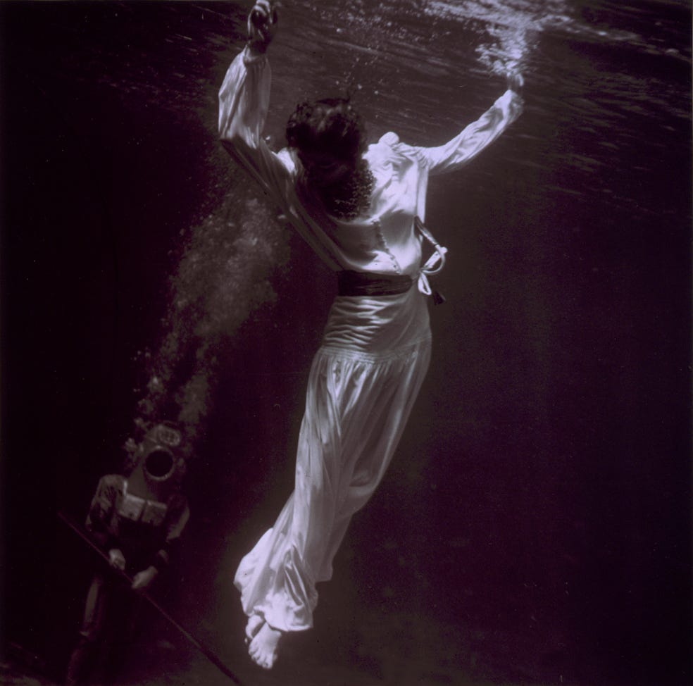Tony Frissell. Fashion model underwater with diver in dolphin tank, Marineland, Florida, 1939.