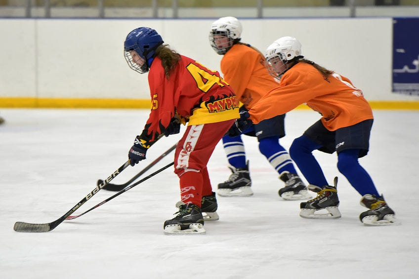 Girls playing hockey