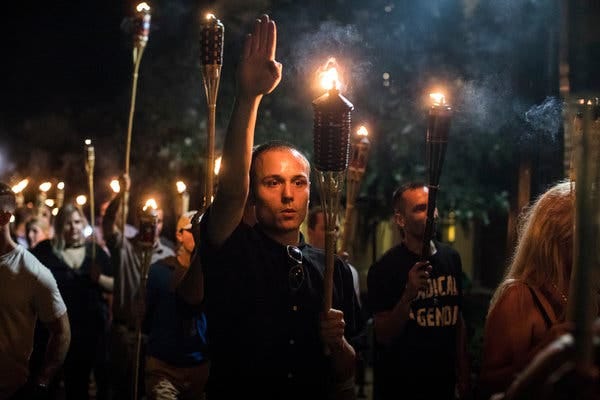 A torch-lit parade of neo-Nazis and segregationists marched through the University of Virginia campus in Charlottesville, Va., on Friday night.