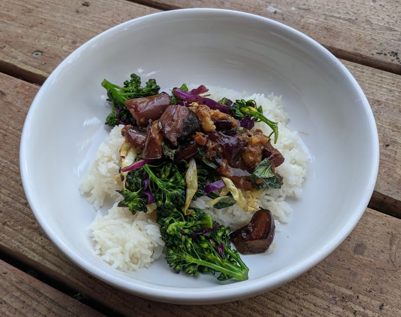 picture of stir-fried eggplant and broccoli over jasmine rice