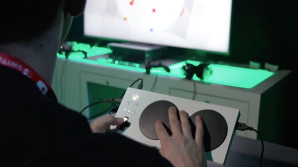 Player using Xbox Adaptive Controller to play HyperDot