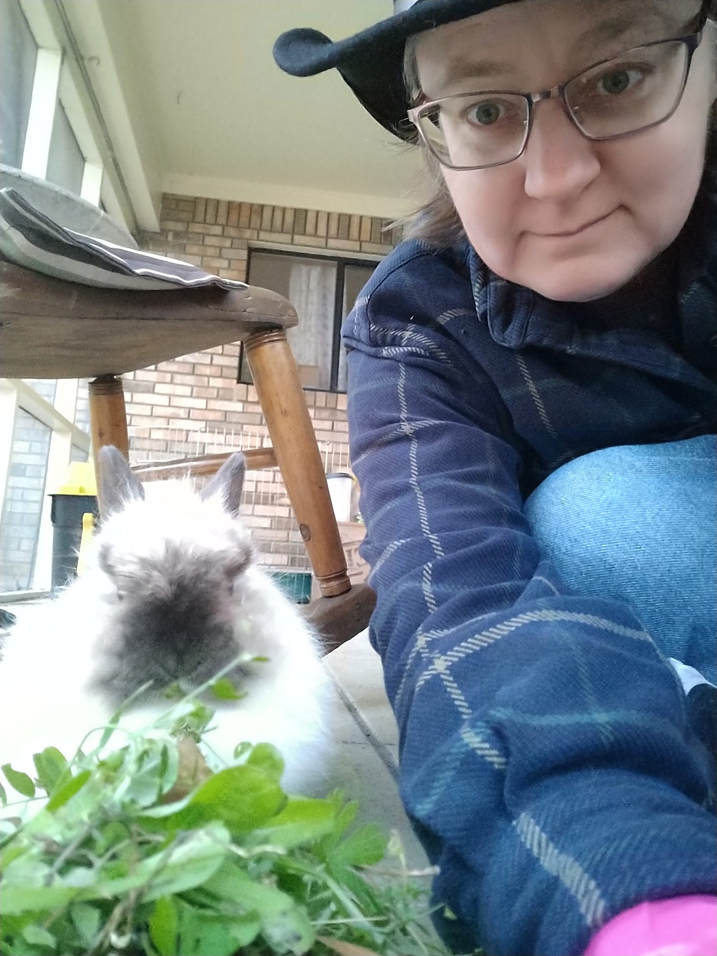 Old selfie of me and Miffy the Bunny, a fluffy white rabbit eating weeds from my yard.