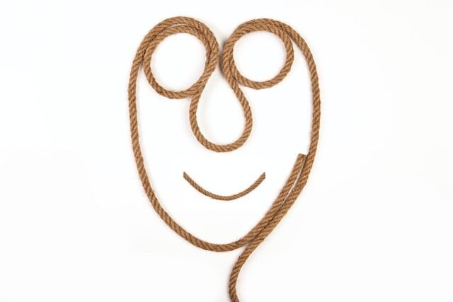 a piece of rope coiled up to have the shape of a smiley face